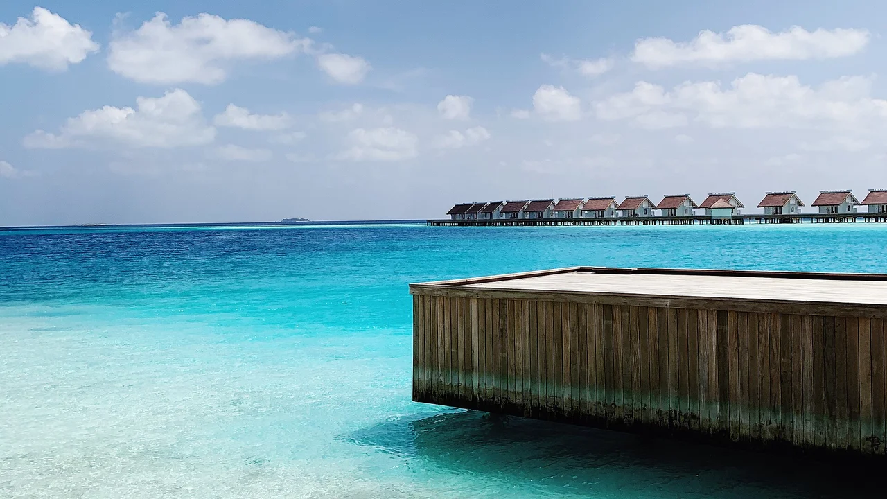 Overwater resort villas in the Maldives with turquoise water